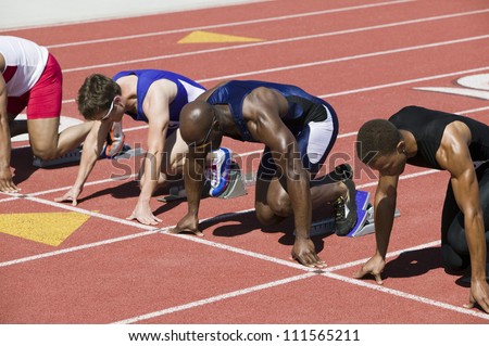 Male athletes at starting line in track race
