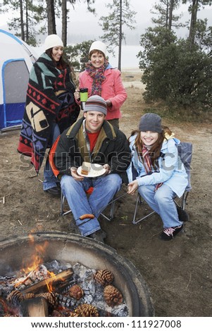Family in front of campfire