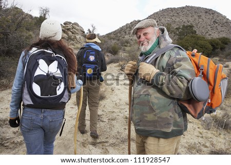 Happy senior man with family on a hiking day