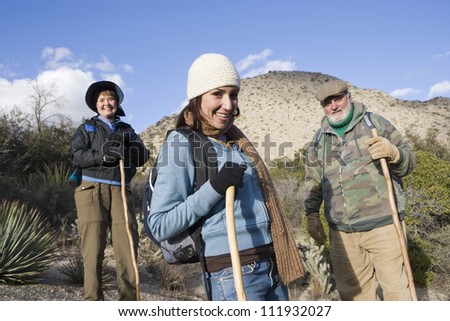 Happy adult woman with parents on hiking trip