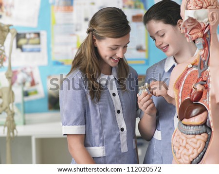 Two students in laboratory with anatomical body in the foreground