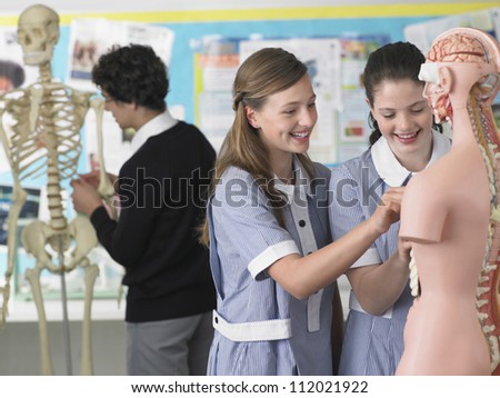 Two students in laboratory with anatomical body in the foreground