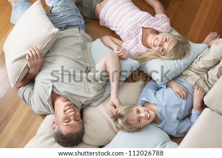 Portrait of happy family lying on floor