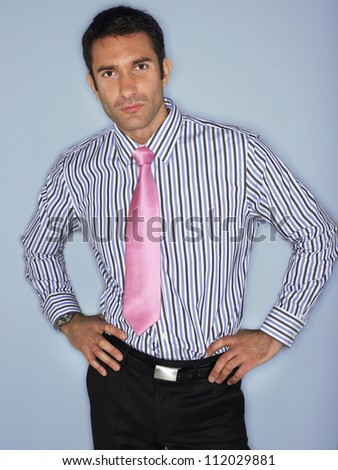 Portrait of handsome businessman over colored background