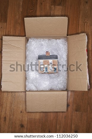 House model on bubble wrap in packing carton