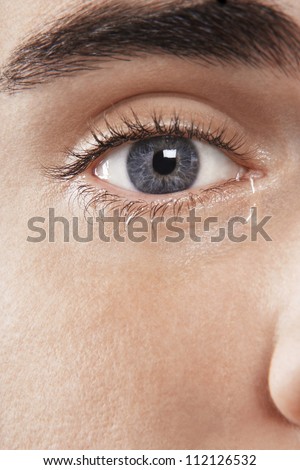 Detail image of man\'s eye crying
