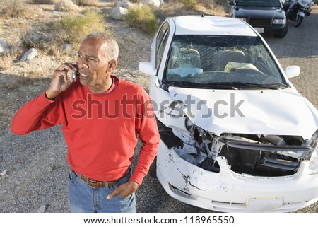 Man talking on phone after car accident