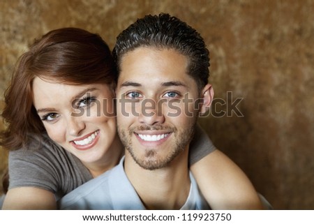 Close-up of beautiful young woman hugging man from behind
