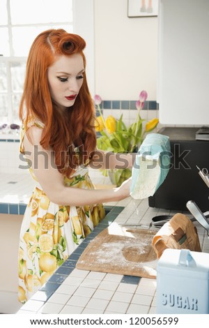 Young redheaded woman in preparation for baking