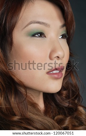 Beautiful Chinese woman with makeup looking away