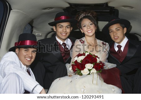 Portrait of a  bride sitting with three male friends in car
