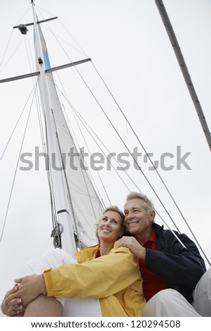Low angle view of a happy Caucasian couple on sail boat during vacations