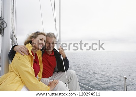 Happy Caucasian couple on vacations in sail boat