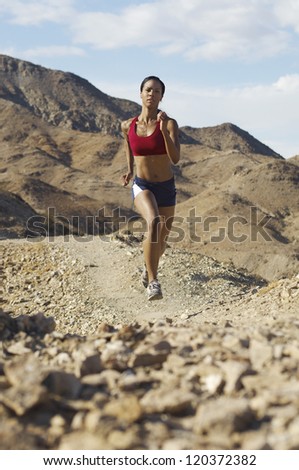Beautiful Mixed race woman jogging in mountains