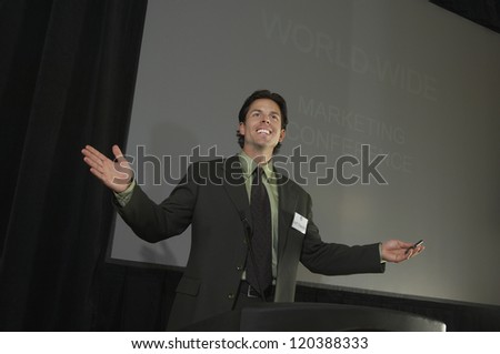 businessman giving a lecture at podium