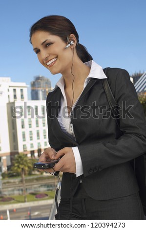 Happy businesswoman on call smiling outdoors