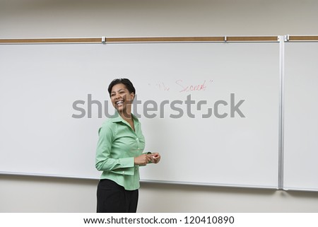 Cheerful female African American professor teaching in classroom