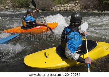 Caucasian teammates river rafting together