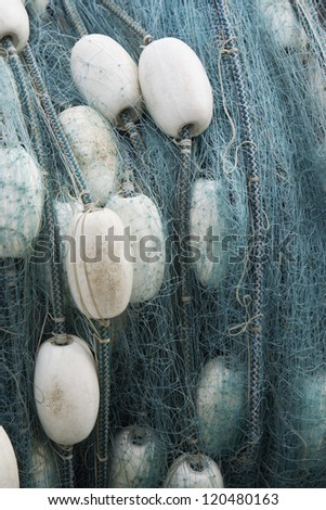 Close up of a rolled up commercial fishing net with floats