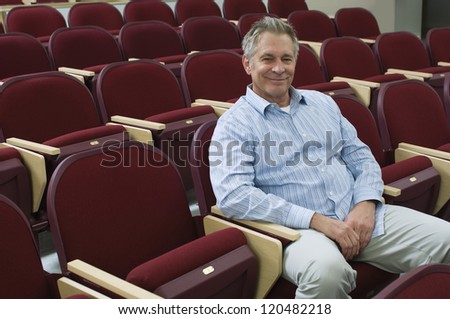 Portrait of a middle aged businessman sitting in a training room after a seminar