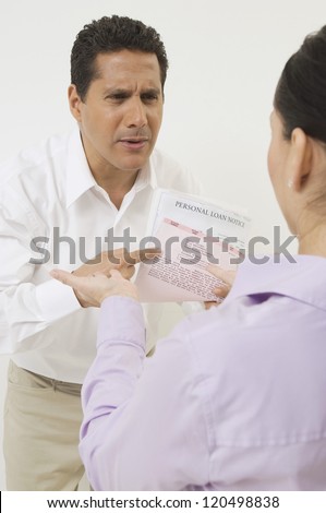 Businessman arguing with woman over documents isolated over white background