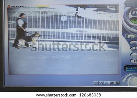 Digital screen showing picture of a cop walking with dog