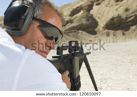 Closeup of a man in shooting position on shooting range