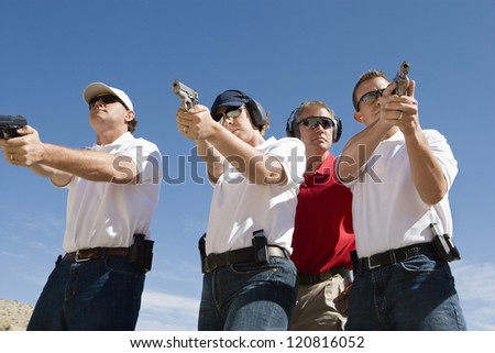 Lieutenant standing with troops holding guns on training