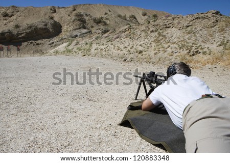 Closeup of a man in shooting position on shooting range