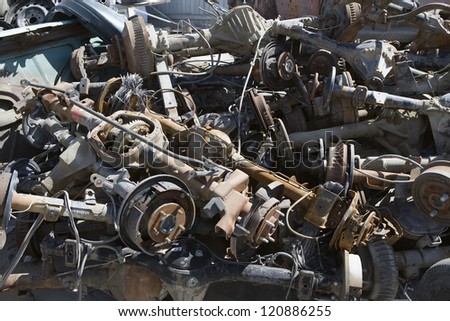 Crushed and damaged car parts at junkyard