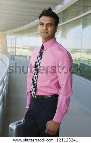 Portrait of an Indian young businessman standing in the office balcony