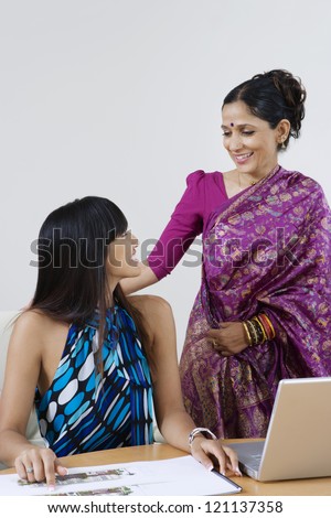 Portrait of beautiful Indian business women looking at each other