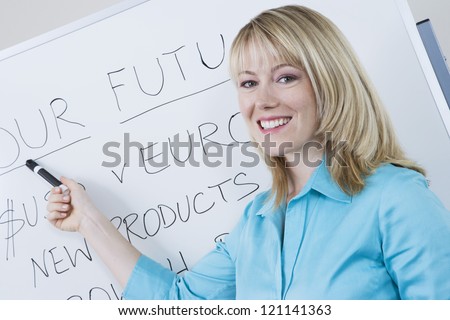 Portrait of a happy business woman presenting company goals