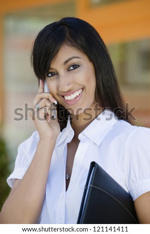 Portrait of an happy Indian business woman on call