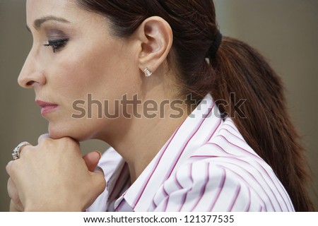 Side view of a business woman day dreaming