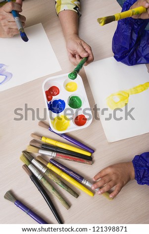High angle view of female student with teacher in art class