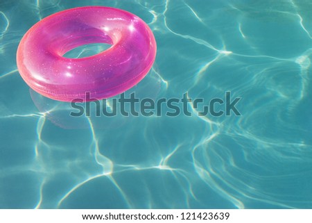 An inflatable tube floating on water in swimming pool
