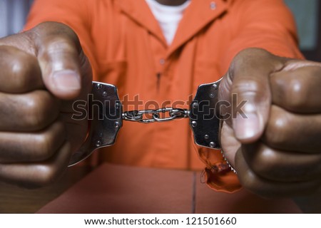 Close up of a prisoner hand\'s fettered with handcuffs