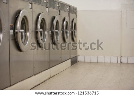Row of self-service clothes dryers in Laundromat