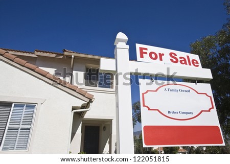 Low angle view of house with \'For Sale\' sign