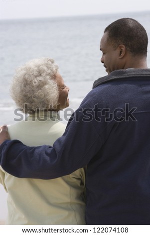 Happy mother and son looking at each other with sea in the background