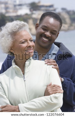 Happy African American mother and  son standing together