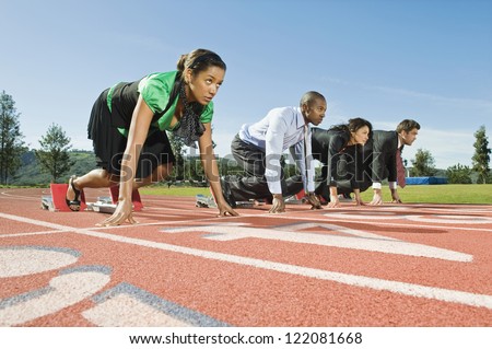 Low angle view of multi ethnic business people at starting position on race track