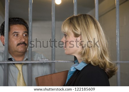 Female lawyer meeting with client in jail for discussion