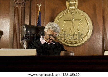 Tired female judge sleeping in courtroom