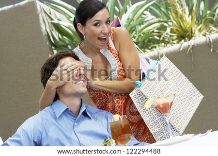 Portrait of playful woman covering man\'s eyes