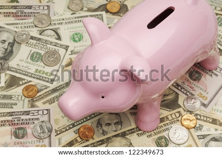 Piggy bank kept on American dollar bills
