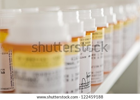 Bottles of pills arranged on shelf at drugstore