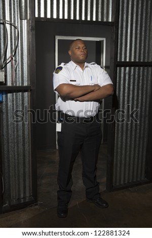 Security guard standing with arms crossed