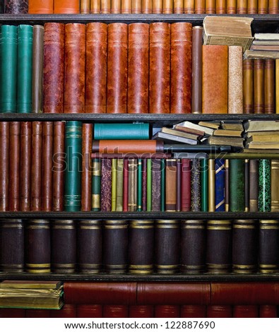 Row of old books arranged in bookshelves
